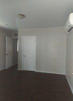 A room with a white door and a window.